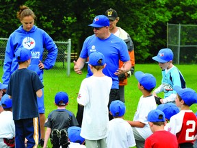 Wayne Parro, a coach with the Canadian National Women's Baseball Team, explains a drill to a group of local Little League players during Sunday's Toronto Blue Jays Baseball Academy clinic at Legion Field. (STEVE PETTIBONE The Recorder and Times)