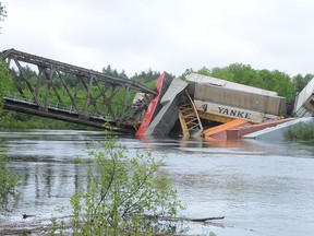 Emergency officials are on the scene of train derailment on Highway 537 in Wanup, just south of Sudbury Ontario on Sunday, June 2, 2013.
A train trestle over the Wanapitei River has collapsed and a number of train cars have fallen into the river.

GINO DONATO/THE SUDBURY STAR/QMI AGENCY