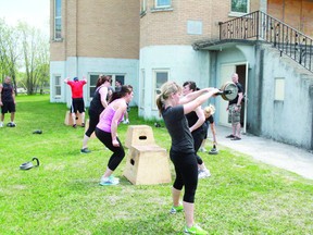 Fitness instructor David White (right) supervises a Cross Fit Kenora class during a lunch hour exercise session outside the Ukrainian Greek Orthodox Church of St. Vladimir on Eighth Street North, Tuesday, May 28, 2013. The lunch time group works out five days a week to improve strength, cardio-vascular and muscular development.
REG CLAYTON/Daily Miner and News