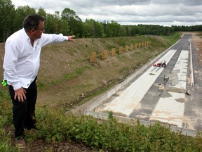 Allan Dell, project manager for King of the North Dragway and Event Park in Bonfield, points toward the start line of the one-eighth mile track, Sunday, June 2, 2013. The track will officially open Saturday.