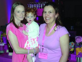 SUBMITTED PHOTO   Krystal Moreau holds her daughter, Abbigail, during the fundraiser "Kisses for Abbigail" held last Friday night in Rankin. They are joined by event organizer Debbie Peplinskie.