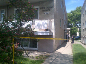 Police taped off a walk-up apartment building, 8328 Jasper Ave., after a man’s body was found Monday morning. (PAMELA ROTH/EDMONTON SUN)