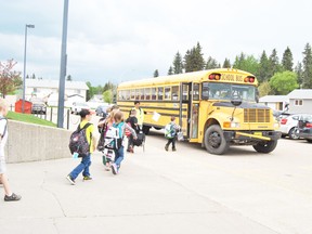 Pat Hardy assistant principal, Jackie Mines, helps direct one of the animal groups to their proper bus on Tuesday, May 28.
Barry Kerton | Whitecourt Star
