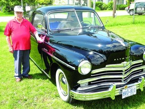 Gananoque's Tom Neal proudly polishes his prized 1949 Plymouth at the Lions Club car show. Almost 50 vintage cars and trucks were on display at the annual car show in Town Hall Park.                   Wayne Lowrie - Gananoque Reporter