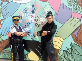 Const. Shannon Neff of the Portage RCMP stands with Nereo II of the Grafitti Gallery in Winnipeg. The pair unveiled the community mural the helped to create, Monday, which now stands on the Family Resource Centre building on Princess Ave. (ROBIN DUDGEON/PORTAGE DAILY GRAPHIC/QMI AGENCY)