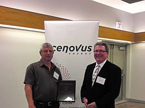 Albert Bryski, left, presents Rams coach Jim Skitsko with a $5,000 donation to the Bantam team’s college bursary program. Photo supplied