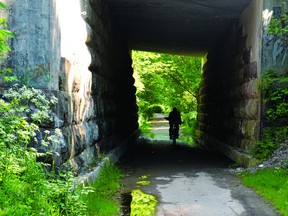 A cyclist rides through the tunnel under the railway bridge on the Brock Trail near Brock Street Monday afternoon. (RONALD ZAJAC/The Recorder and Times)