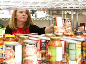 Lynn Spencer checks expiry dates and organized donations at the food bank during the second annual Love High River event.