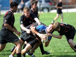 The Northern Vikings need three defenders to bring down St. Chris Cyclone Josh Frankland in the LSSAA senior boys Rugby Finals Wednesday, May 29, 2013 at SCITS in Sarnia, Ont. PAUL OWEN/THE OBSERVER/QMI AGENCY