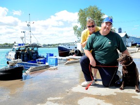 Hunter is one lucky dog and Point Edward's Carolyn Luciani is one relieved dog owner after Captain Tim Purdy and his commercial fishing crew rescued the chocolate lab from the St. Clair River recently. BLAIR TATE / FOR THE OBSERVER / QMI AGENCY.