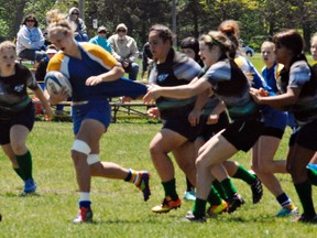 Brooke Newsome of BCI gets her jersey pulled during the opening game Monday of the Ontario Federation of School Athletic Associations AAA/AAAA girls rugby championship in Waterloo. (Expositor Photo)