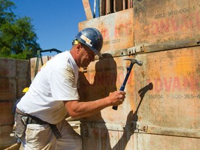 Rob Snyder of CoFo Concrete Forming assembles the forms Monday that will be soon poured to make a new basement for a home in the cities northeast corner. Snyder says he?s worked in concrete for ?almost 40 years.? (MIKE HENSEN, The London Free Press)