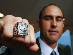 Argonauts quarterback Ricky Ray poses with his Grey Cup ring during a ceremony last week. He doesn't plan to change his approach entering his second season with the team. (ERNEST DOROSZUK/Toronto Sun)