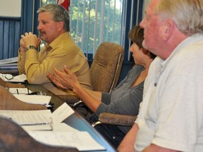 Councillors Rob Layng, left and Les Coutlee listen as fellow councillor Kim Sytsma speaks during Monday night's council meeting in Athens. (STEVE PETTIBONE The Recorder and Times)