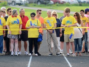 02 TRENTON, ON., (05/31/2013) Trenton resident and Trenton High School student Zack Fellows, 14, cuts a ribbon to mark the beginning of the Survivors Lap Friday, May 31, 2013 at the first Quinte West/THS community Relay for Life. Zack is a thyroid cancer survivor. 
EMILY MOUNTNEY/TRENTONIAN/QMI AGENCY