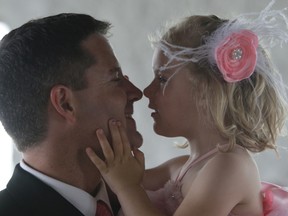 David Elzinga and his three-year-old daughter Blythe Elzinga share a moment during the Faces of the Soup Kitchen fundraiser held at the St. Marys Paper Mill Square on Saturday. Elzinga was part of the Alyssa and Jeff Hunter wedding party that attended the event.