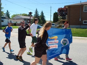 Regan Pilatzke, a probation and parole officer from Sudbury, carries the torch as the annual Law Enforcement Torch Run for Special Olympics made its way from North Bay Police headquarters to the waterfront Tuesday. The annual event helps to raise awareness and funds for Special Olympics.