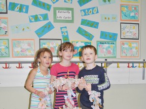 Sophia Danks, 5, Victoria Ferguson, 6 and Jimmy Ferguson, 4, hold one of Pat Hardy School’s Kindness Wreaths. The wreaths started out the year bare but as the year went on students were able to cover the wire structures with ribbons. Each ribbon represents one act of kindness. To get a ribbon a student must have been nominated by another student or staff member saying they did something kind.
Barry Kerton | Whitecourt Star