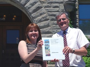 St. Thomas Mayor Heather Jackson and CAO Wendell Graves hold a copy of the city's first-ever strategic plan outside city hall Tuesday.