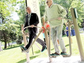 Chatham-Kent Mayor Randy Hope, left, and West Kent Coun. Bryon Fluker take a walk in the park during the grand opening of eight outdoor fitness stations at Odette Seniors Garden Park in Tilbury, Tuesday. A ribbon cutting was held in the park to celebrate the opening of the eight stations, which are located along the park's 500-metre trail. KIRK DICKINSON/FOR CHATHAM DAILY NEWS/ QMI AGENCY