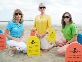 SARAH DOKTOR Times-Reformer
The Simcoe Community Policing Committee and Norfolk County Aquatics have joined together to promote water safety through the flutter board tombstone campaign. Aquatics supervisor Lisa DeSerrano, chair of the Simcoe Community Policing Committee Carol Greentree-Gibbons and Water Safety Awareness Promoter Olivia Woodley show off the tombstones at the Port Dover beach.