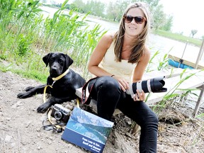Chatham photographer Sarah Williams, and her eight-month-old lab Indy, are set to document the natural beauty of Ontario for a new book slated to print in September. Williams, a world traveller, hopes her series Lens to Eye encourages Canadians and others to explore Canada. PHOTO TAKEN CHATHAM, ON., Wednesday May 22, 2013. DIANA MARTIN/ THE CHATHAM DAILY NEWS/ QMI AGENCY