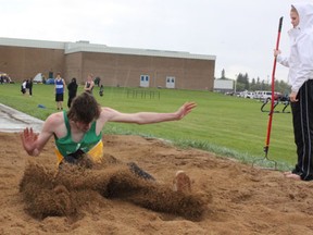 MUCC athlete Ty Pederson has a muddy landing while competing at the NESSAC Track and Field Meet at MUCC Field on Tuesday, May 28.