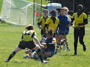 BCI's Manon Clarke is taken down during action Tuesday at the Ontario Federation of School Athletic Associations AAA/AAAA girls rugby championship in Waterloo. BCI will play for a bronze medal on Wednesday. (Expositor photo)