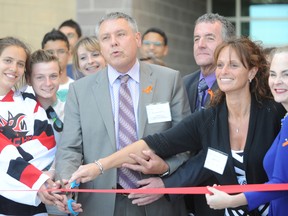 Ronald Marion (centre), chair of Conseil scolaire Viamonde, opens the new École secondaire Franco-Jeunesse with the help of Tanya Tamilio, chair of Centre scolaire communautaire de Sarnia, and education superintendent Jennifer Lamarche Schmalz. The French public school board held an official opening ceremony Tuesday for the $9.5 million new school building and francophone community centre. BARBARA SIMPSON / THE OBSERVER / QMI AGENCY