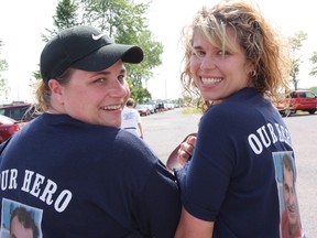 ALS walk co-ordinator Melissa Ferguson and Amanda Mayer pay tribute to Peter Ferguson, who was diagnosed with the disease at age 32, during last year’s fundraising walk. This year the event is scheduled for Saturday, June 8, at St. Lawrence College.
File photo