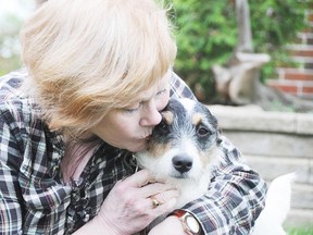 Diane O'Reilly, lcuddles with her dog Jack at her home in Copper Cliff.
GINO DONATO/THE SUDBURY STAR