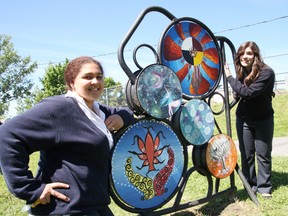 College Notre Dame students Karissa Ellis, left, and Kirsten St-Louis show their artwork which is part of the Ste. Anne's Public Art Walk located at the Ste. Anne Road green stairs in Sudbury, ON. on Tuesday, June 4, 2013. More than 40 paintings created by students at Marymount Academy, College Notre Dame and Sudbury Secondary School are on display. JOHN LAPPA/THE SUDBURY STAR/QMI AGENCY