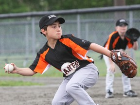 Ben White of the Moose's Cookhouse Giants delivers a pitch against the Red Sox in North Bay Baseball Association mosquito division action at Optimist Park, Monday.