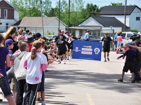 Runners in Petawawa’s Special Olympics Law Enforcement Torch Run in 2013 receive heroes’ welcomes at Our Lady of Sorrows school. The annual event is being held across the Ottawa Valley on Tuesday.