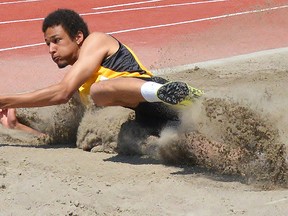 Trenton High Tigers' Leaguen Fray completes a gold medal leap in the senior men's long jump Friday at the East Regional track and field championships at Belleville's M.A. Sills Park. Fray also won the high jump and placed second in the triple jump.