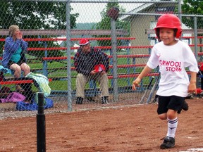 A proud Jesse Bidgood, 7, runs to home during his T-Ball game Saturday during Norwood Minor Softball's Opening Day festivities. LINDSEY BOWMAN/Community Press/Special to QMI AGENCY