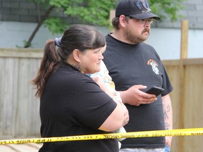 Point Edward homeowner Nicole Sauve and her son Shawn Campbell watch an anthropologist dig up bones found in their Alexandra Avenue backyard. BARBARA SIMPSON / THE OBSERVER / QMI AGENCY