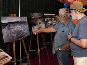 Bill Stevens and Gary Van Dorp look at some old photos of Vanastra before the BR and E presentation.