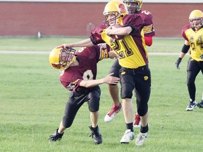 Dalton Letawski, #21, gets his arm on an opponent and breaks away for the end zone during the Sabres spring camp Toilet Bowl game June 3.