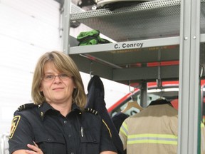 New deputy chief Cindy Conroy stands by her locker in the West Fire Hall in Wetaskiwin May 30.