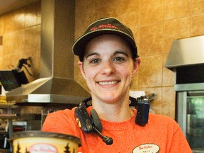 Katie Kornelson serves a cup of Tim Hortons' popular coffee at the Saskatchewan Avenue store during Wednesday's Camp Day. A portion of every Tim Hortons coffee sold goes towards funding to send an economically disadvantaged youth to camp. Last year's Camp Day raised a record $11 million, which sent more than 15,000 kids on a camping adventure. (Svjetlana Mlinarevic/Portage Daily Graphic/QMI Agency)