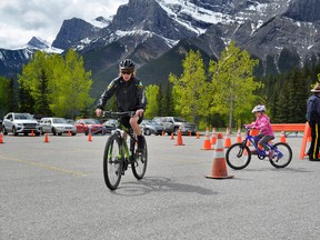 Officer Cheryl Dubuc leads the way as Sydney McLaren practices her bike safety at the Bicycle Safety Rodeo at the Canmore Nordic Center on Saturday, June 1. TERA SWANSON/ BANFF CRAG & CANYON/ QMI AGENCY.