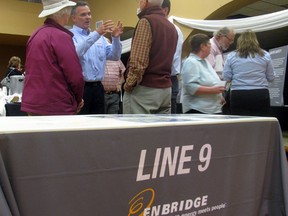 Kingston residents speak to Enbridge staff regarding the proposed flow reversal of the Line 9 pipeline, during an open house Wednesday. 
Alison Shouldice/For The Whig-Standard