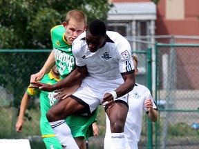 Mallan Roberts, in white, was red-carded and suspended for one game following this collision with a Tampa Bay player in Sunday's game at Clarke Stadium. (David Bloom, Edmonton Sun)