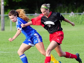 St. Thomas defender Melissa Renno, right, pushes aside the advance of West Lorne's Emily Varga as the sides played to a 2-2 draw in LAWSL Second Division action Wednesday at Athletic Park. R. MARK BUTTERWICK / St. Thomas Times-Journal / QMI AGENCY
