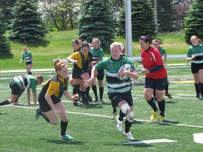 Katie Hiltz of the Grey Highlands Lions tries to turn the corner on Beamsville's Bridget McMillan during the team’s OFSAA A/AA senior girls rugby consolation final on Wednesday.
