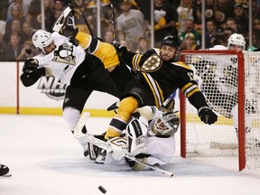 Penguins defenceman Deryk Engelland pushes Bruins forward Milan Lucic into goaltender Tomas Vokoun during Game 3 of the NHL Eastern Conference final at TD Garden in Boston, June 5, 2013. (WINSLOW TOWNSON/Reuters)