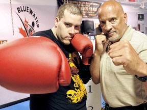 Tyler Dionne, left, will make his amateur boxing debut Saturday with his father, KAYO coach Floyd Porter, in his corner at the Moose Lodge. (MARK MALONE/The Daily News)
