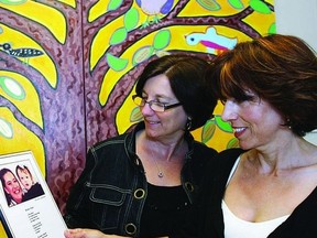 Joanne Young, executive director for Kingston Interval House, (KIH) and Cristina Duchesneau, vice-chair on the board of directors, look at a portrait of Robin and her granddaughter, for whom Robin’s Hope, KIH’s transitional housing facility is named. The two were busy planning the upcoming Butterfly Ball fundraiser for KIH, which is taking place at the Renaissance Event Venue on June 6.     ROB MOOY - KINGSTON THIS WEEK