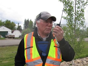 Volunteer Hubert Johnson of the Northern Alberta Radio Club provides communication using a hand held radio at the Fallen 4 Marathon start site, the Fallen Four Memorial Park in Mayerthorpe on Sunday, June 2.